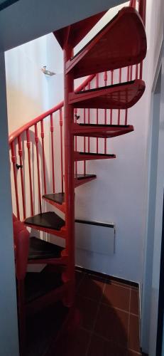 a red spiral staircase in a room at Il Rustico ticinese di Brè in Brè sopra Lugano