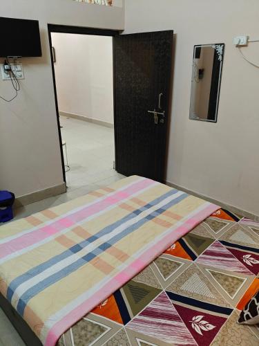a bed sitting on the floor in a room at Anjani Home - 3Bhk Homely & GroundFloor Appartment for Families in Varanasi