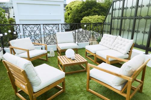 a group of chairs and tables on a balcony at IoTele南青山 in Tokyo