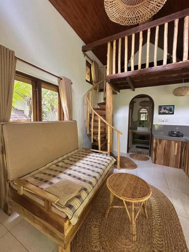 a living room with a bench and a staircase at The Tree House in Arugam Bay