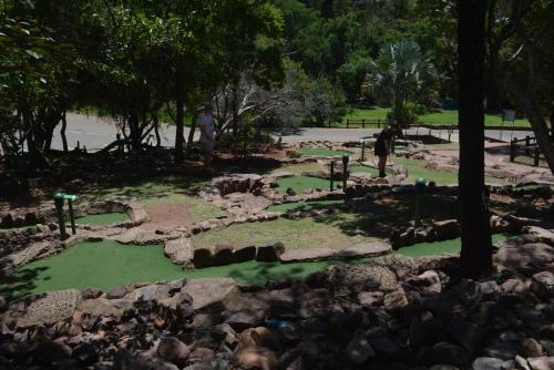 a miniature golf course in a park with people playing golf at ATKV Klein-Kariba in Bela-Bela