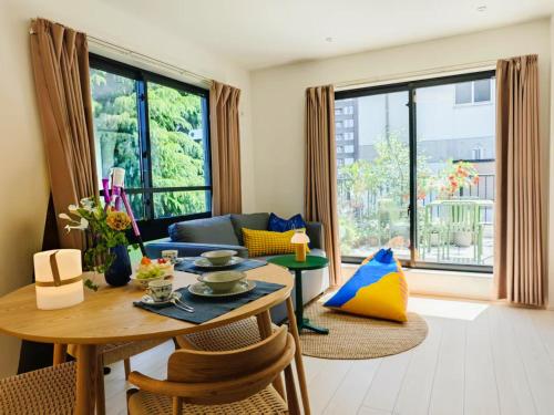 a living room with a table and a couch at Mi-HOTEL ATELIER SHINJUKU in Tokyo