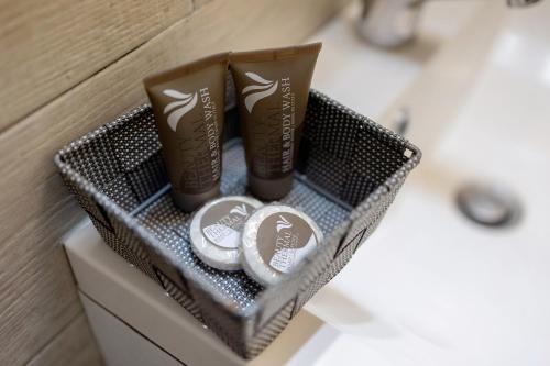 a basket with two rolls of toilet paper on a bathroom vanity at Camere Amè in Peschiera del Garda