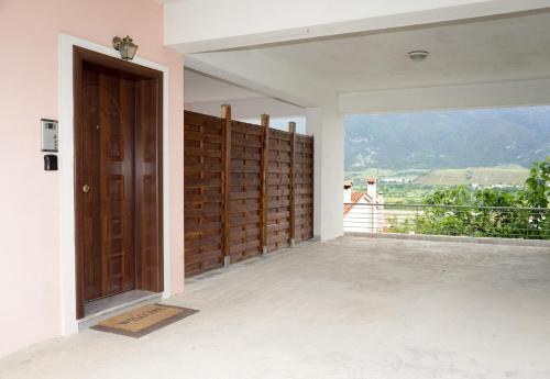 an empty room with a door and a balcony at Unlimited view - elegant apt 59 m2 w 37 m2 balc w prk in Ioannina
