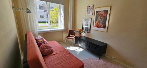 a living room with a couch and a window at Sadama Holiday Apartment in Kõrgessaare
