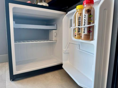 an open refrigerator filled with bottles of sauce at Prūsų Jūra in Svenele