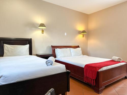 a hotel room with two beds in a room at Park Gables Loftus Guest House in Pretoria