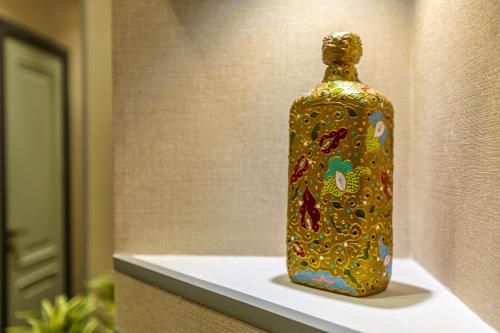 a colorful bottle sitting on a shelf at Nizami Central Park Hotel in Baku