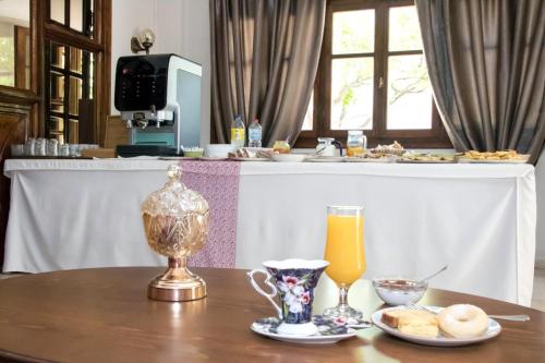 a table with a drink and a cup of orange juice at Eva Marina Hotel in Matala