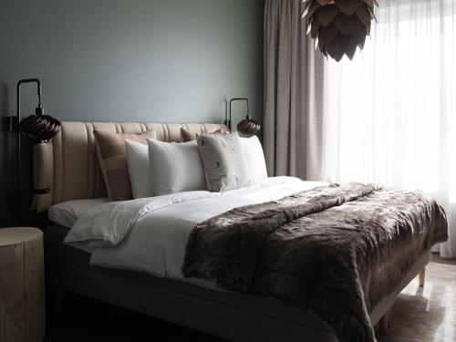 a bedroom with a large bed with a large window at Elite Hotel Frost - Hotel & Spa in Kiruna