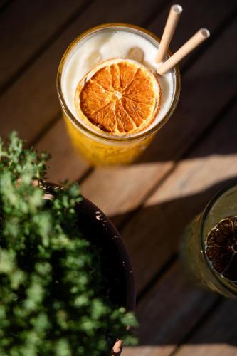 a drink with a slice of orange on a table at LA FERME DE LA HUPPE in Gordes