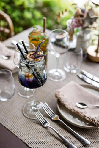 a table with a glass with a drink on it at LA FERME DE LA HUPPE in Gordes