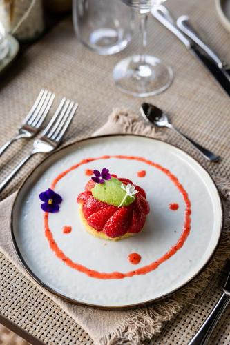 a plate with a strawberry dessert on a table at LA FERME DE LA HUPPE in Gordes