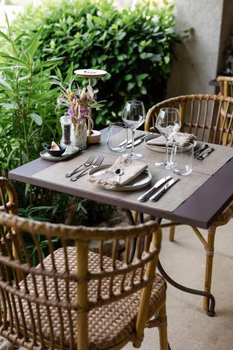 a table with glasses and silverware on it at LA FERME DE LA HUPPE in Gordes