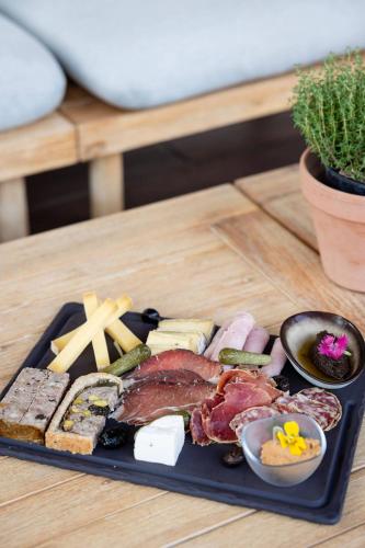 a plate of food with meat and vegetables on a table at LA FERME DE LA HUPPE in Gordes