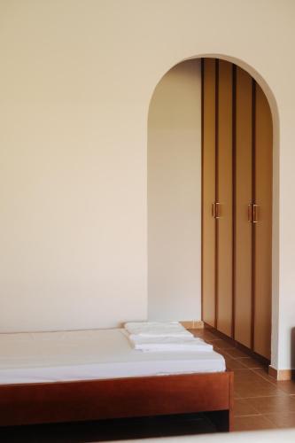 a room with a bed and a closet at Finikas Apartments in Plakias