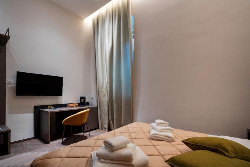a bedroom with a bed and a desk and a television at 4 Season Cognetti in Bari