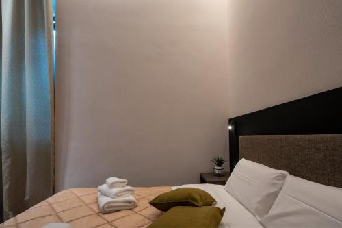 a bedroom with a bed with towels on it at 4 Season Cognetti in Bari