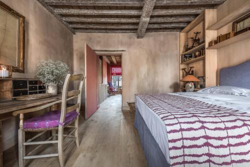 a bedroom with a bed and a desk and a chair at Odevaere - Charming & luxurious apartment with terrace in Bruges