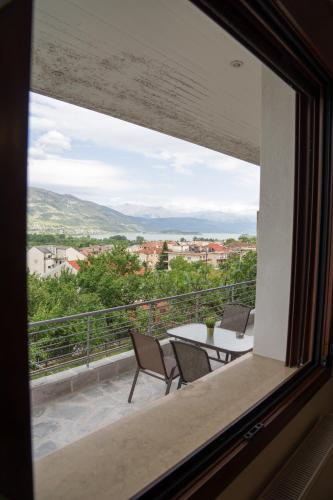 a window view of a balcony with a table and chairs at Unlimited view - elegant apt 59 m2 w 37 m2 balc w prk in Ioannina