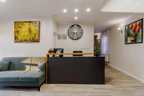 a living room with a couch and a reception desk at Хотел Арбанашко село in Arbanasi