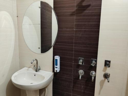 a bathroom with a sink and a mirror at Maira Retreat in Faridabad