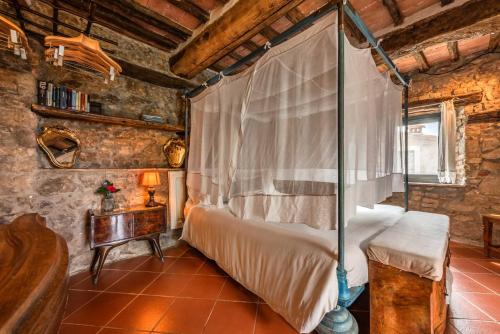 a bedroom with a bed with a canopy at B&B Podere Camaiano in Roccastrada
