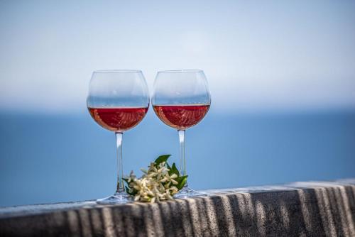 two glasses of wine sitting on a table at Sea Whisper Villa Peloponnese in Arkadiko Chorio