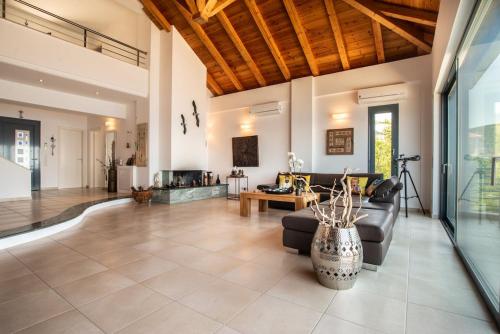 a living room with a couch and a table at Sea Whisper Villa Peloponnese in Arkadiko Chorio