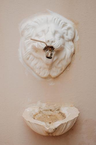 a white object on a wall with a bee on it at Finikas Apartments in Plakias