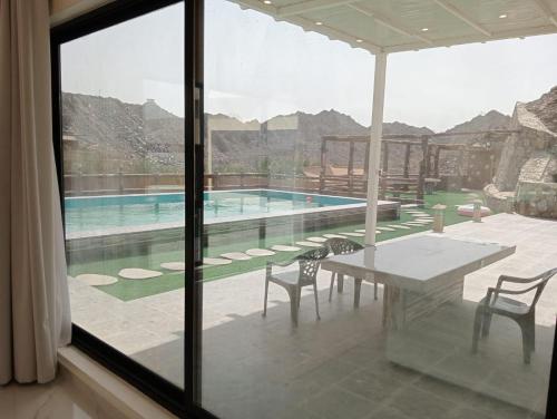 a view of a swimming pool from a house at Hatta Guest house Resort in Būbādī