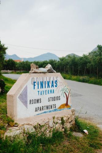 a sign for a school on the side of a road at Finikas Apartments in Plakias