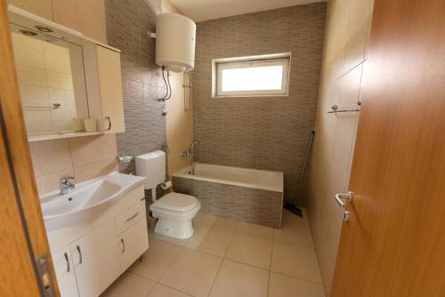 a bathroom with a toilet and a tub and a sink at Villa Sarajevo 6 in Sarajevo