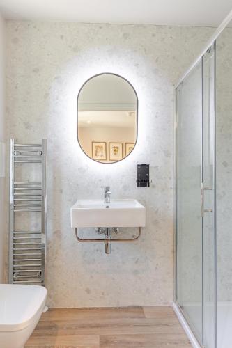 a bathroom with a sink and a mirror at Grove House Hotel in Edinburgh