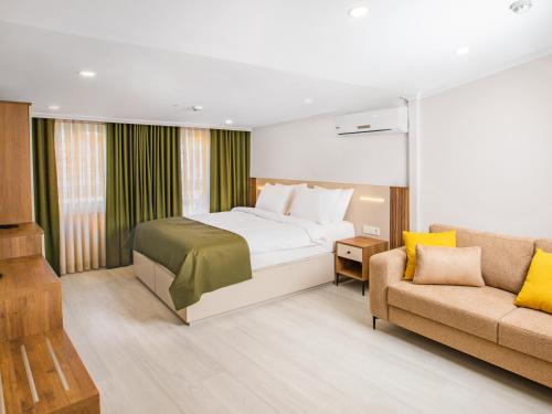 a bedroom with a bed and a couch at Quinnova Hotel in Istanbul