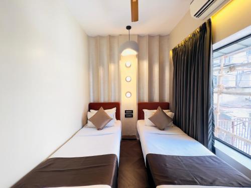 Hotel White Pearl - Colaba Mumbaiにあるベッド
