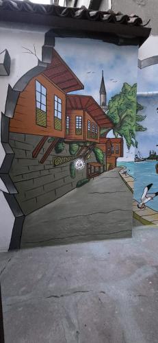 a painting of a house on the side of a wall at Grand Bedir in Istanbul
