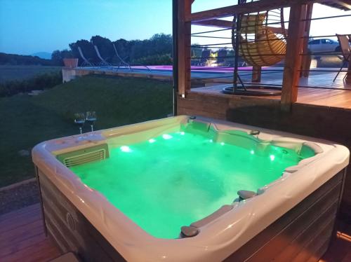a hot tub on the deck of a house at Villa Green Relax in Gornji Mihaljevec