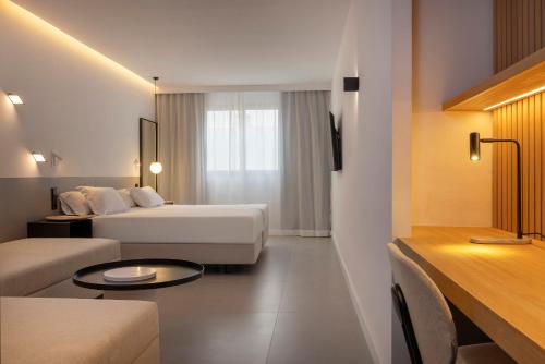 a hotel room with a bed and a couch at HM Jaime III in Palma de Mallorca