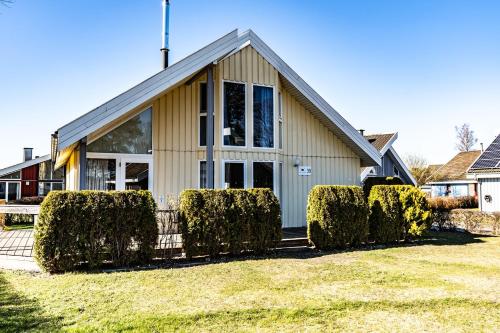 a house with bushes in front of it at SATAMA Sauna Resort & SPA in Wendisch Rietz