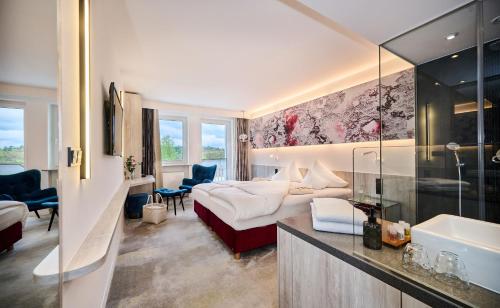 a hotel room with a couch and a bed at Hotel Wutzschleife in Rötz