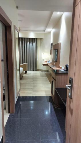 a hotel room with a hallway with a hotel room at The Rajgir Residency in Rājgīr