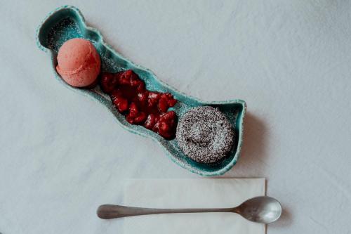 a bowl of red caviar next to a spoon at Fészek -Étel és Hotel- in Zánka