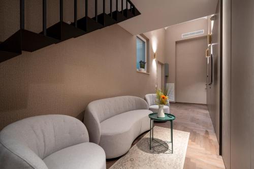 a living room with two chairs and a staircase at 4 Season Cognetti in Bari