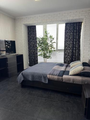 a bedroom with a large bed and a window at Avangard in Chernivtsi