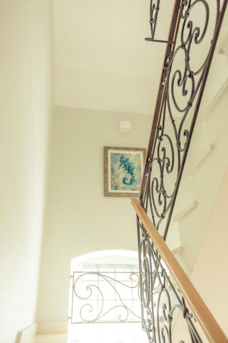 a stairway with a wrought iron railing and a stair case at Villa Toma in Donji Morinj