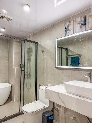 a bathroom with a toilet and a sink and a shower at The Palms Thoddoo in Thoddoo