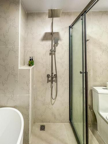 a bathroom with a shower and a toilet and a sink at The Palms Thoddoo in Thoddoo