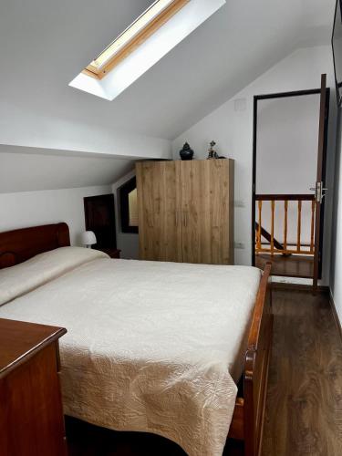 a bedroom with a bed and a wooden cabinet at La Nuti in Sinaia