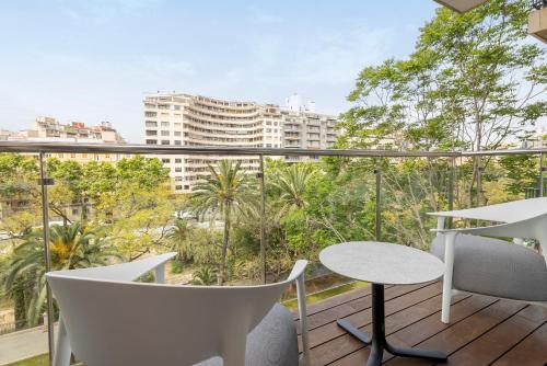 a balcony with a table and chairs and a view of a city at HM Jaime III in Palma de Mallorca